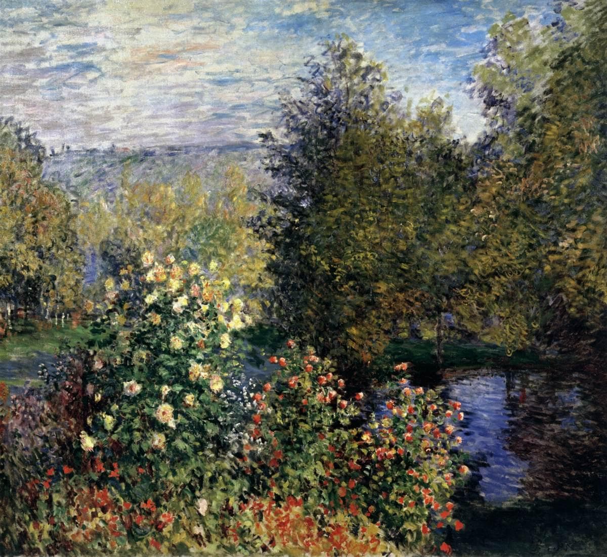 A dense garden of red and yellow dahlias in front of tall trees, a dark pool at right and hazy hills at upper left — Claude Monet, Corner of the Garden at Montgeron, 1876–77