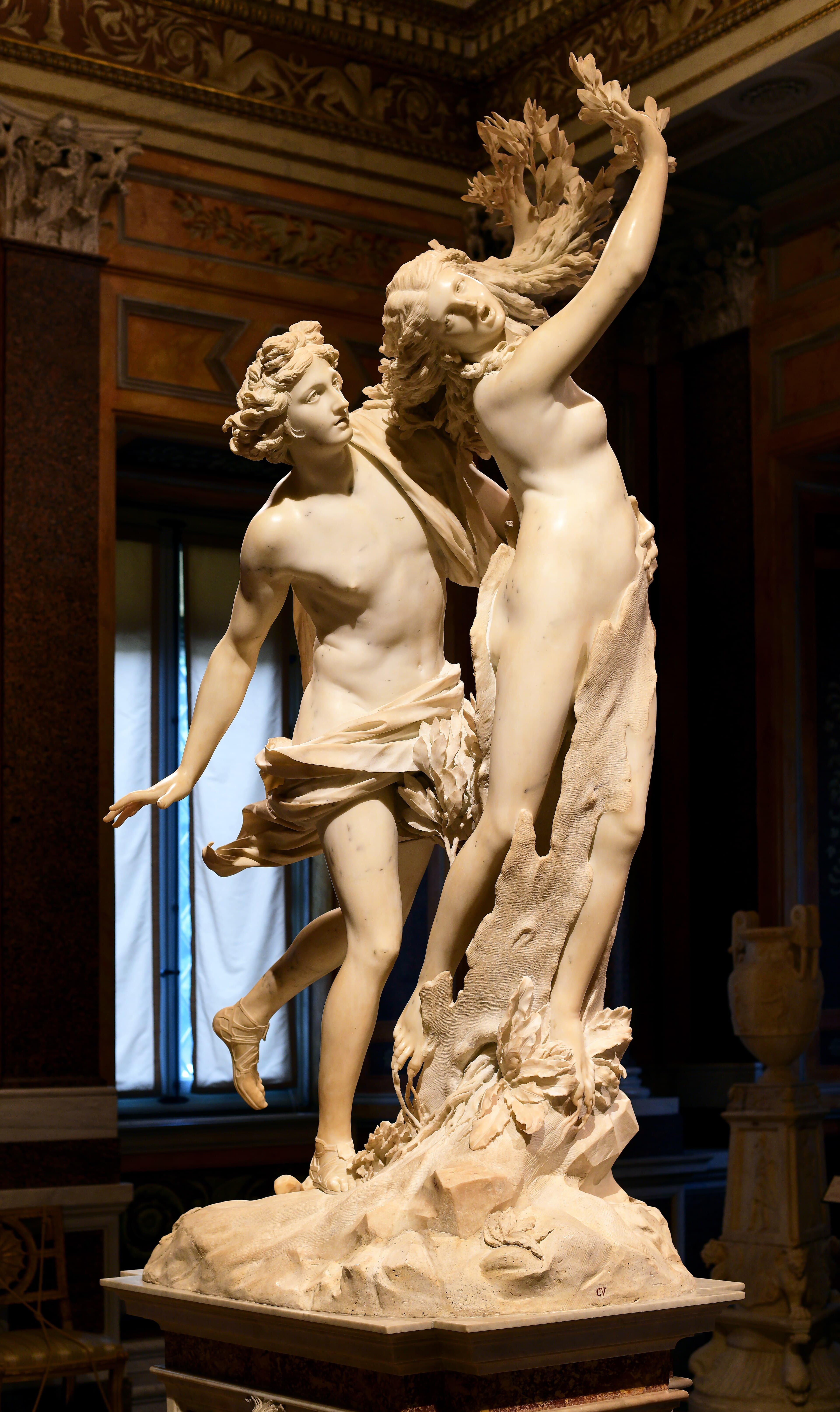 A running young god catches a nymph whose fingers burst into laurel leaves and whose legs are closing in bark — Gian Lorenzo Bernini, Apollo and Daphne, 1622–1625