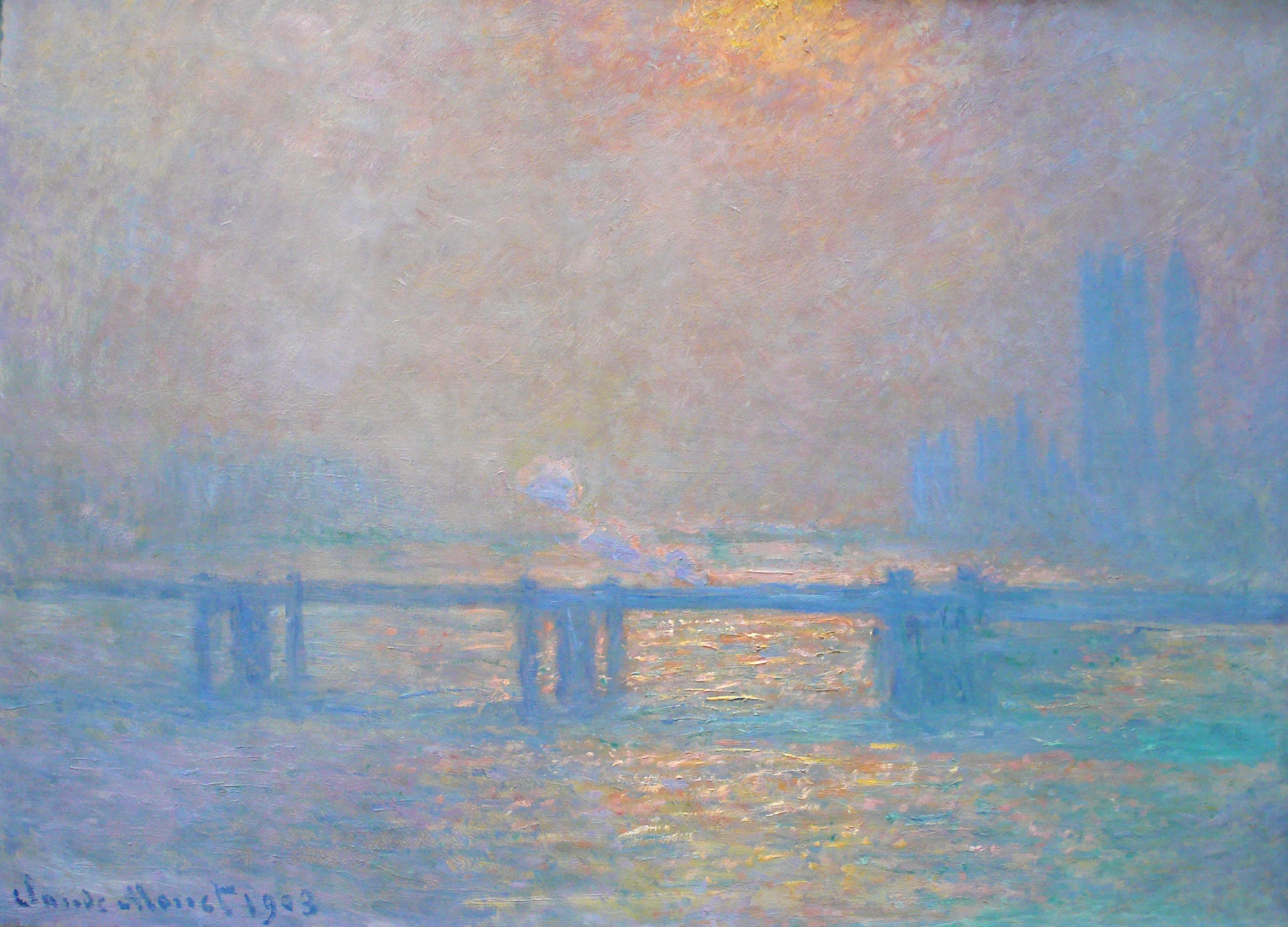 A violet-blue bridge crosses a river glittering gold beneath a pale low sun, with Parliament's towers in haze at right and orange light at the top — Claude Monet, Charing Cross Bridge, The Thames, 1903