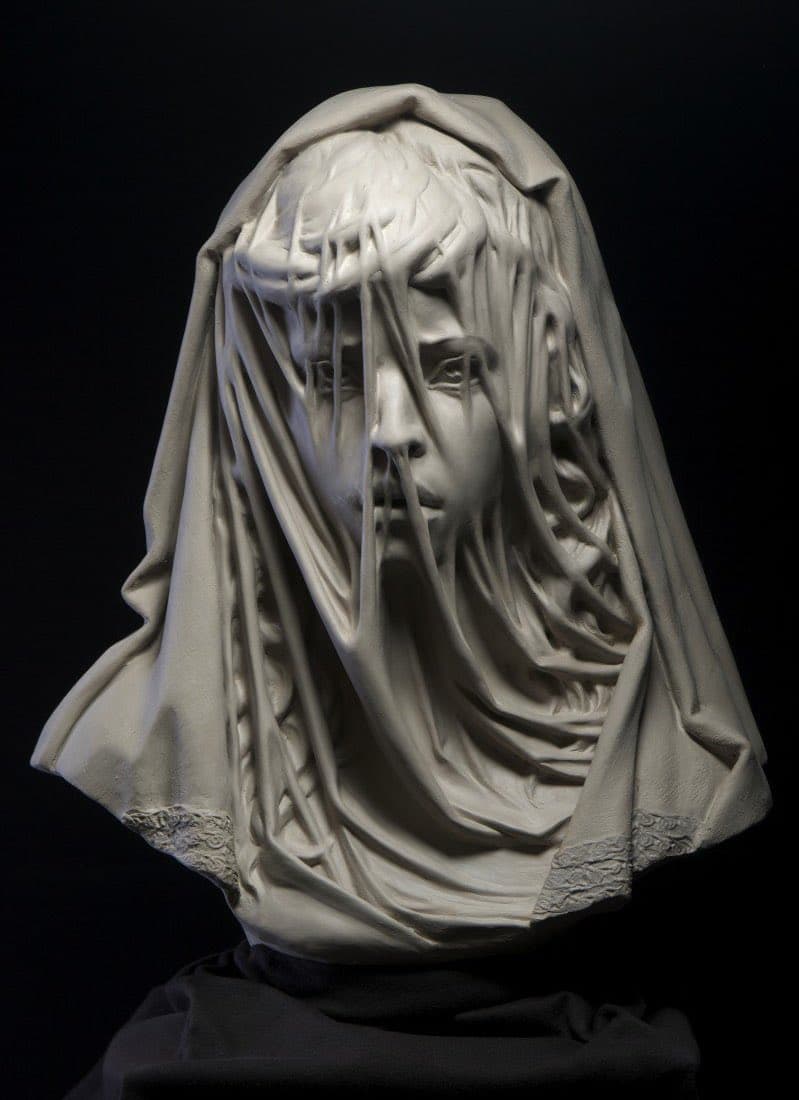 A white bust of a young girl whose face shows through a thin, clinging bridal veil edged with lace — Philippe Faraut, Child Bride, 2014