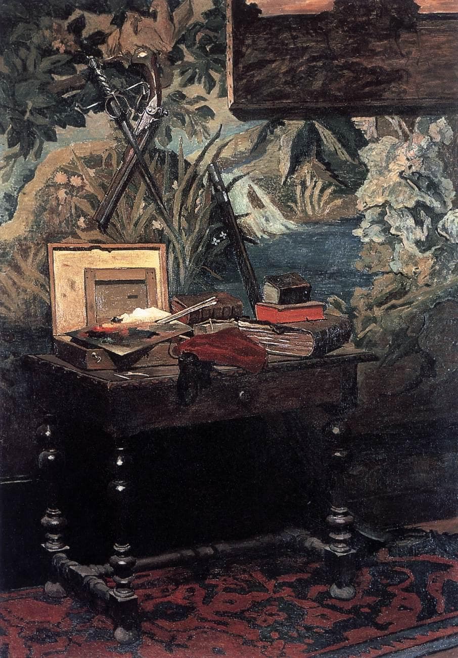 A dark carved table on a red carpet holds an open paint box, palette, books and red cloth before a landscape tapestry hung with a crossed sword and pistol — Claude Monet, Corner of the Studio, 1861