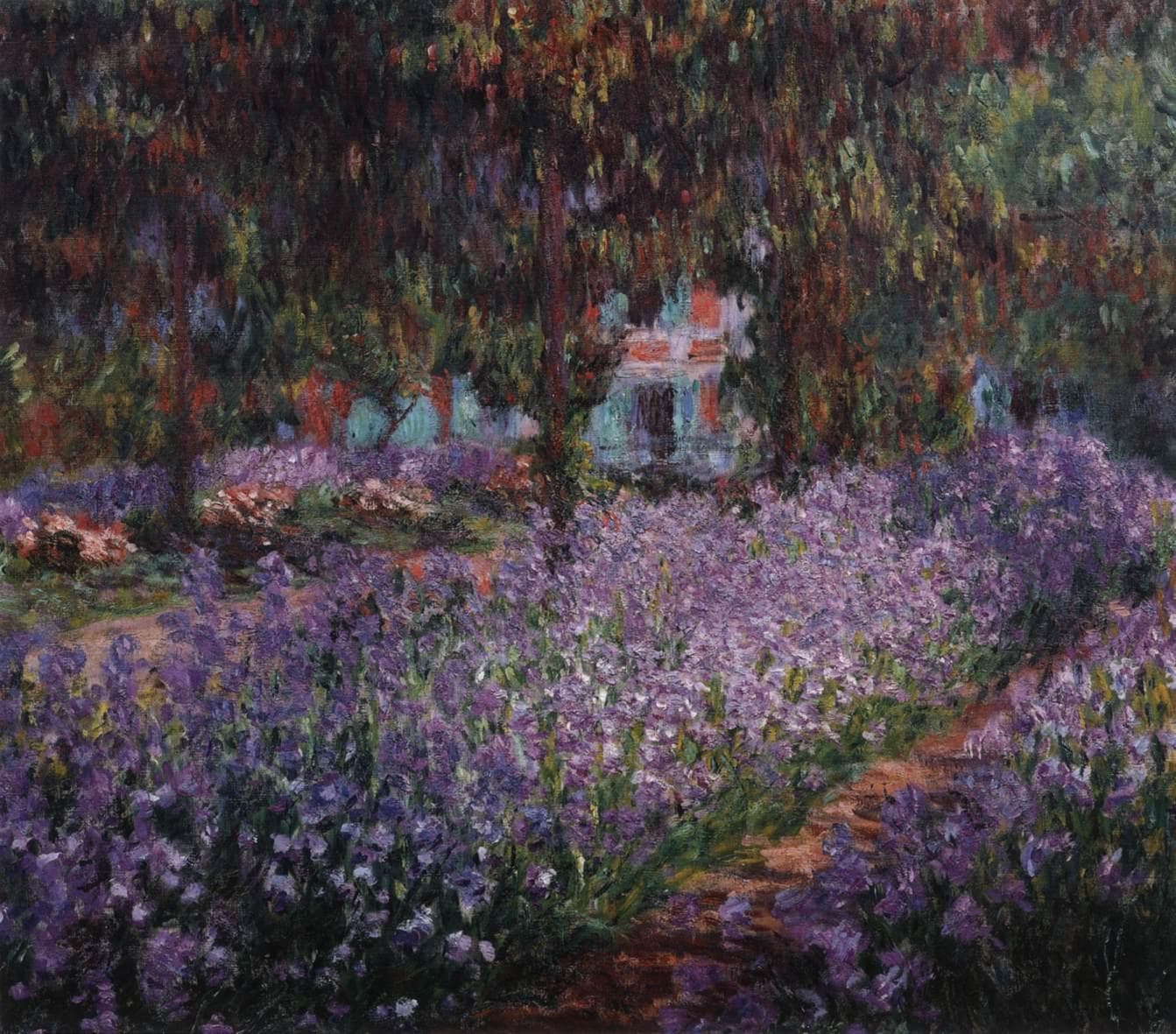 Beds of violet irises fill a garden crossed by a curving pinkish path, with thin trees and hanging red and green foliage above framing a glimpse of a pink house with green shutters — Claude Monet, Irises in Monet's Garden at Giverny, 1900