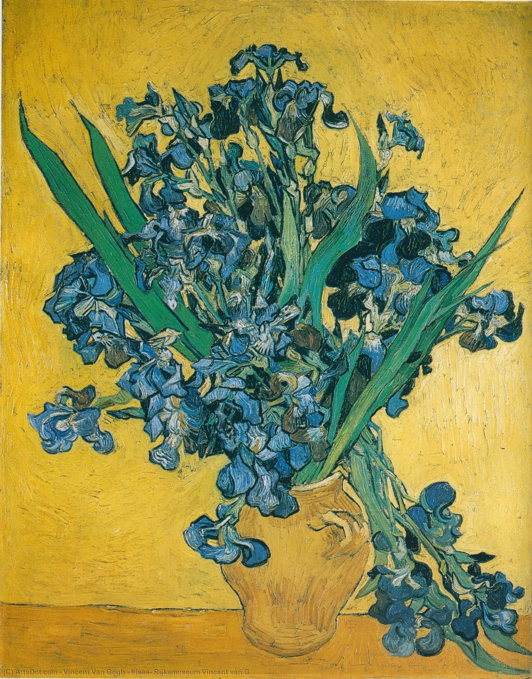 A huge bouquet of blue-violet irises with long green leaves bursts from an ochre vase against a bright yellow wall, stems spilling onto the table — Vincent van Gogh, Irises, 1890