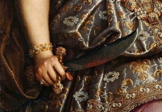 A jeweled hand grips a curved blade against a silver brocade gown woven with gold and pearls — detail of Fede Galizia, Judith with the Head of Holofernes, 1596
