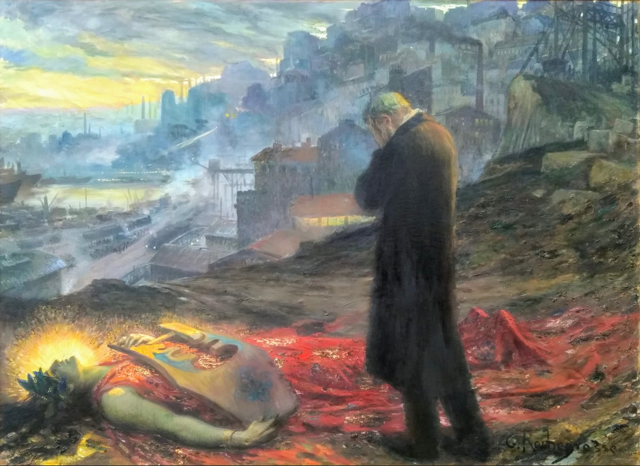 A man in a black coat stands with his hand over his face beside a dead, haloed woman lying on crimson cloth with a painter's palette, above a smoky industrial harbor — Georges Rochegrosse, La Mort de la pourpre, 1914