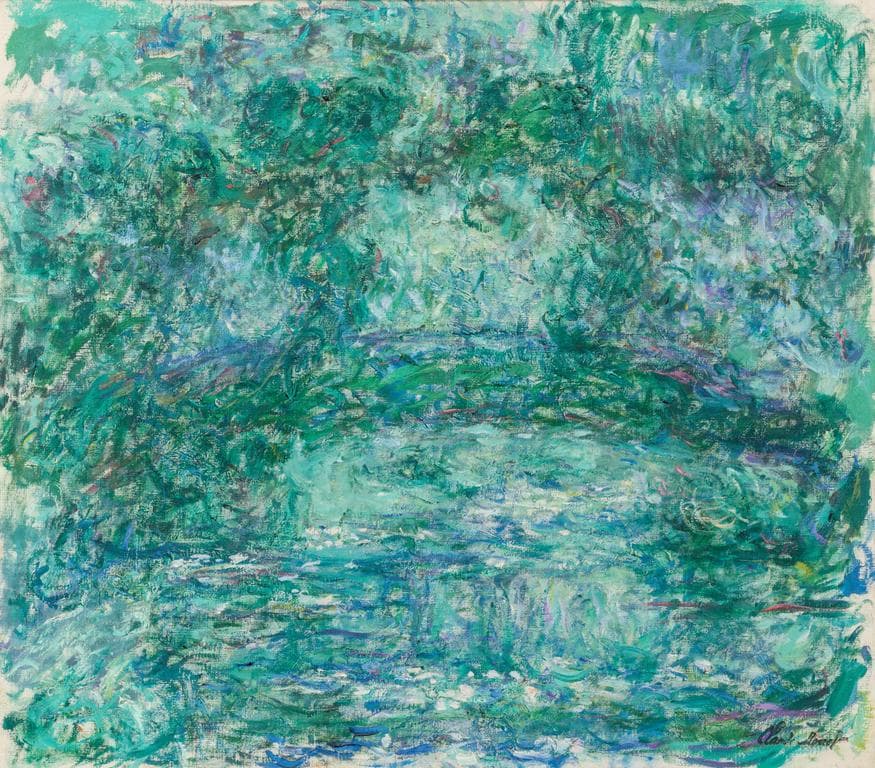 A low blue-green arch spans a milky green pond beneath airy swirls of mint and lilac foliage, signed lower right — Claude Monet, Le pont japonais (Japanese Bridge), 1918–24