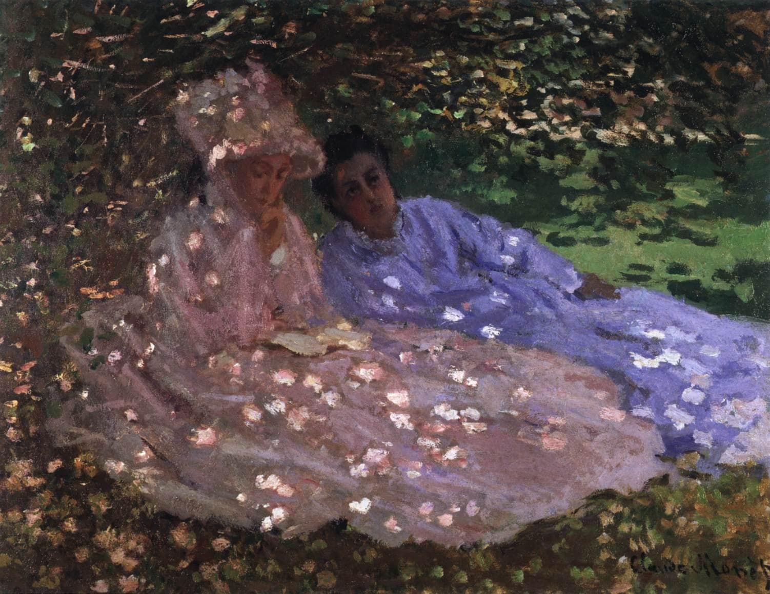 Two women in pink and lilac-blue dresses rest on the grass under a leafy canopy, one reading, flecks of sunlight scattered over them — Claude Monet, Madame Monet and a Friend in the Garden, c. 1872