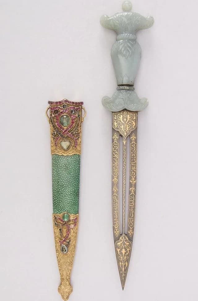 A dagger with a carved pale-green jade hilt and a gold-inlaid steel blade lies beside its green shagreen sheath mounted in gold with rubies and emeralds — Ottoman, Dagger with Sheath, 18th century