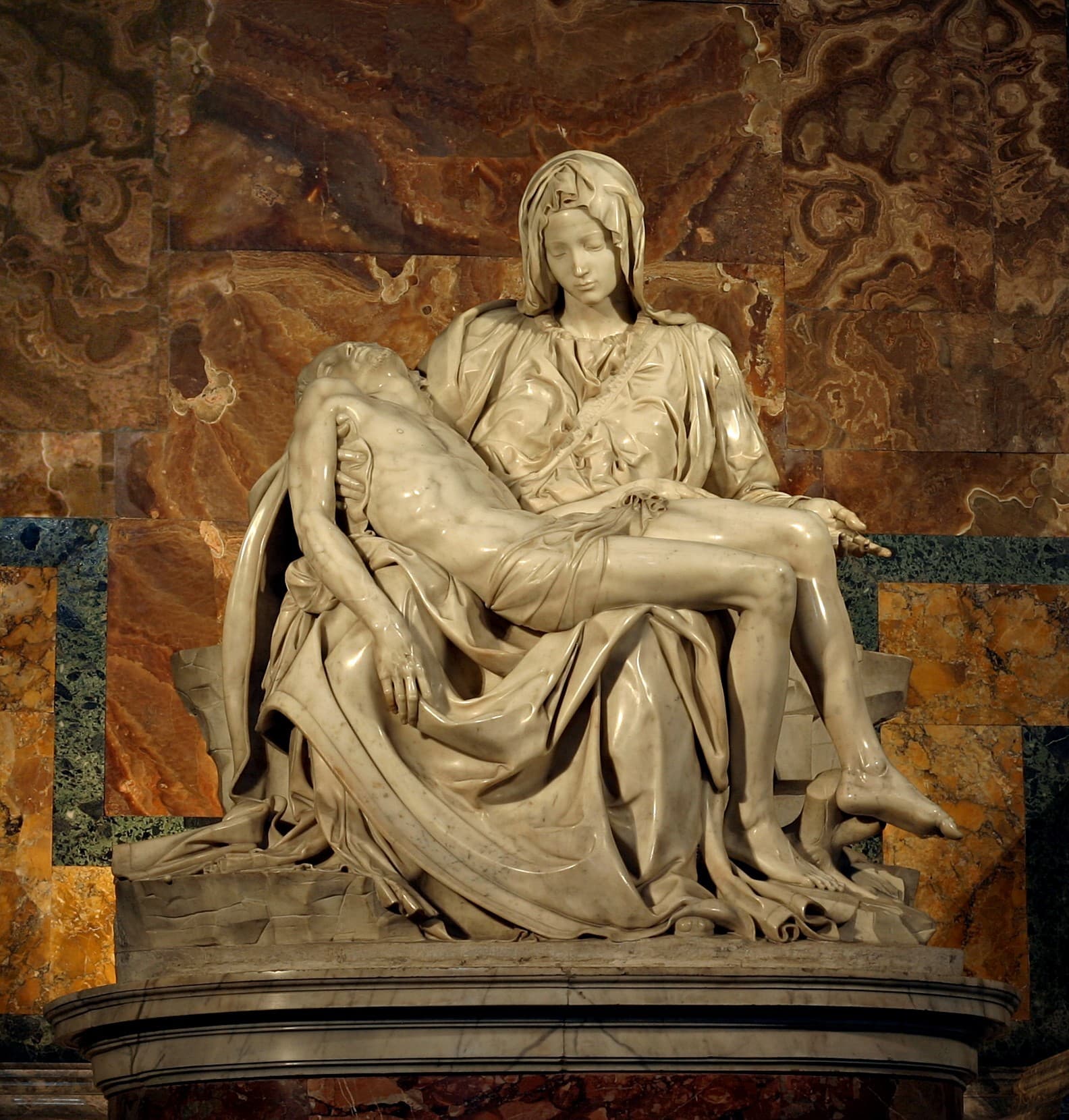 A seated young Virgin Mary in heavy marble drapery holds the limp body of the dead Christ across her lap — Michelangelo, Pietà, 1498–1499