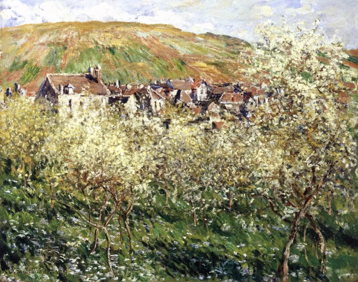 Young plum trees in white blossom stand in windswept green grass, with village roofs and a striped hillside of fields behind — Claude Monet, Plum Trees in Bloom, 1879