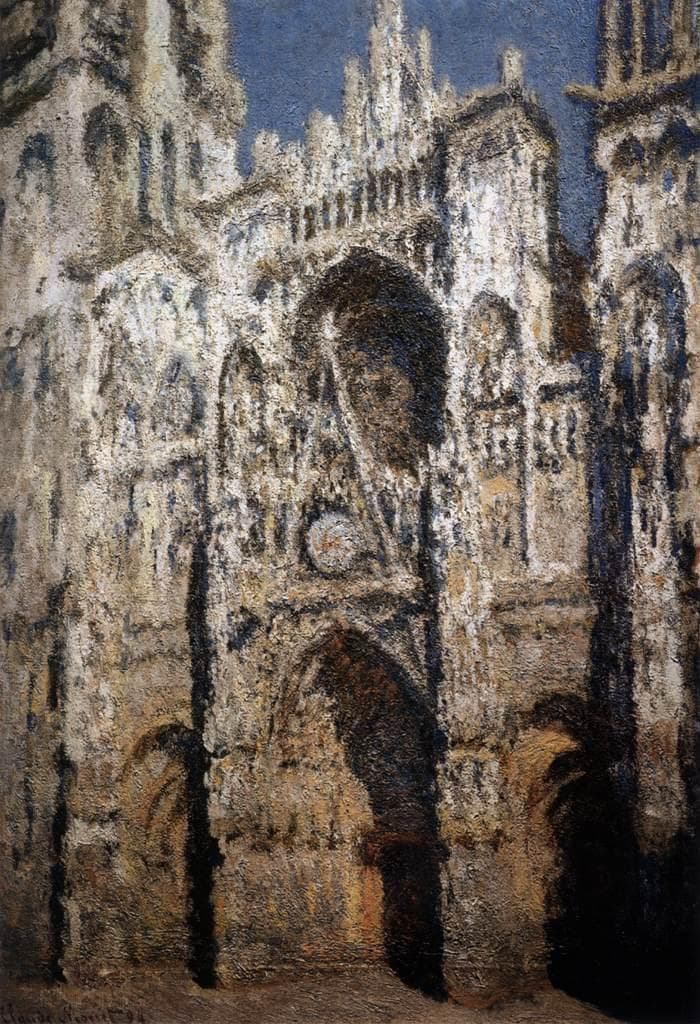The Gothic portal of Rouen Cathedral blazes in gold and cream sunlight, its arches and rose window in deep blue shadow under a patch of blue sky — Claude Monet, Rouen Cathedral in Full Sunlight, 1893