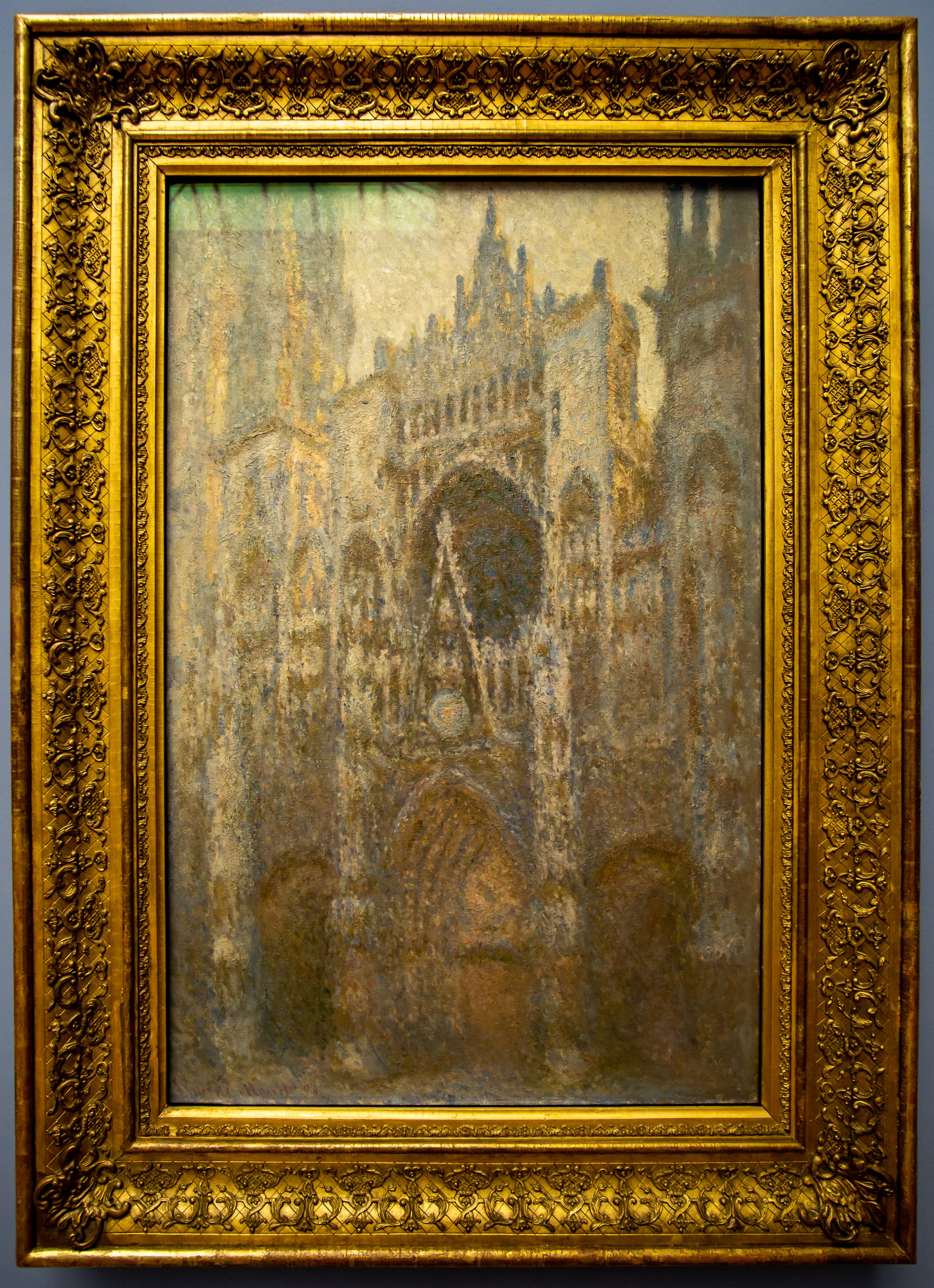 The Gothic façade of Rouen Cathedral in muted ocher, gray and dusty gold under a pale cream sky, a dark rose window above the central portal — Claude Monet, Rouen Cathedral, Portal, 1893–94