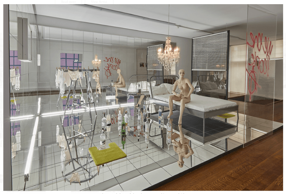 A mirrored room with a steel bed, seated mannequins, chandeliers, bottles, a drying rack and red scrawled words reflected endlessly — Josephine Meckseper, Scene VI, 2019