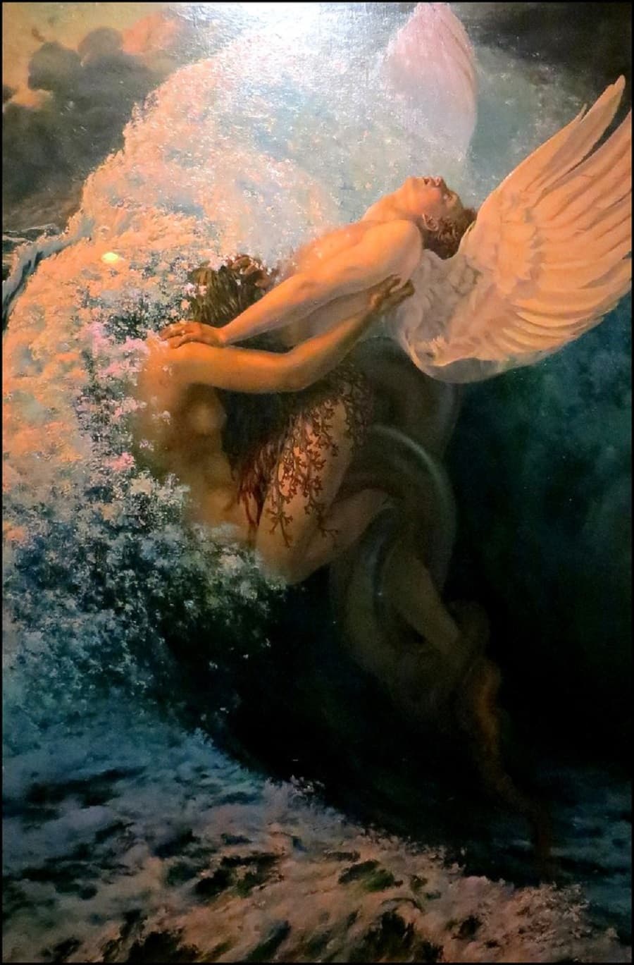 A white-winged youth arches backward inside a breaking wave as a red-haired woman wrapped by a serpent clasps him from below — Carlos Schwabe, Spleen et Idéal, 1907