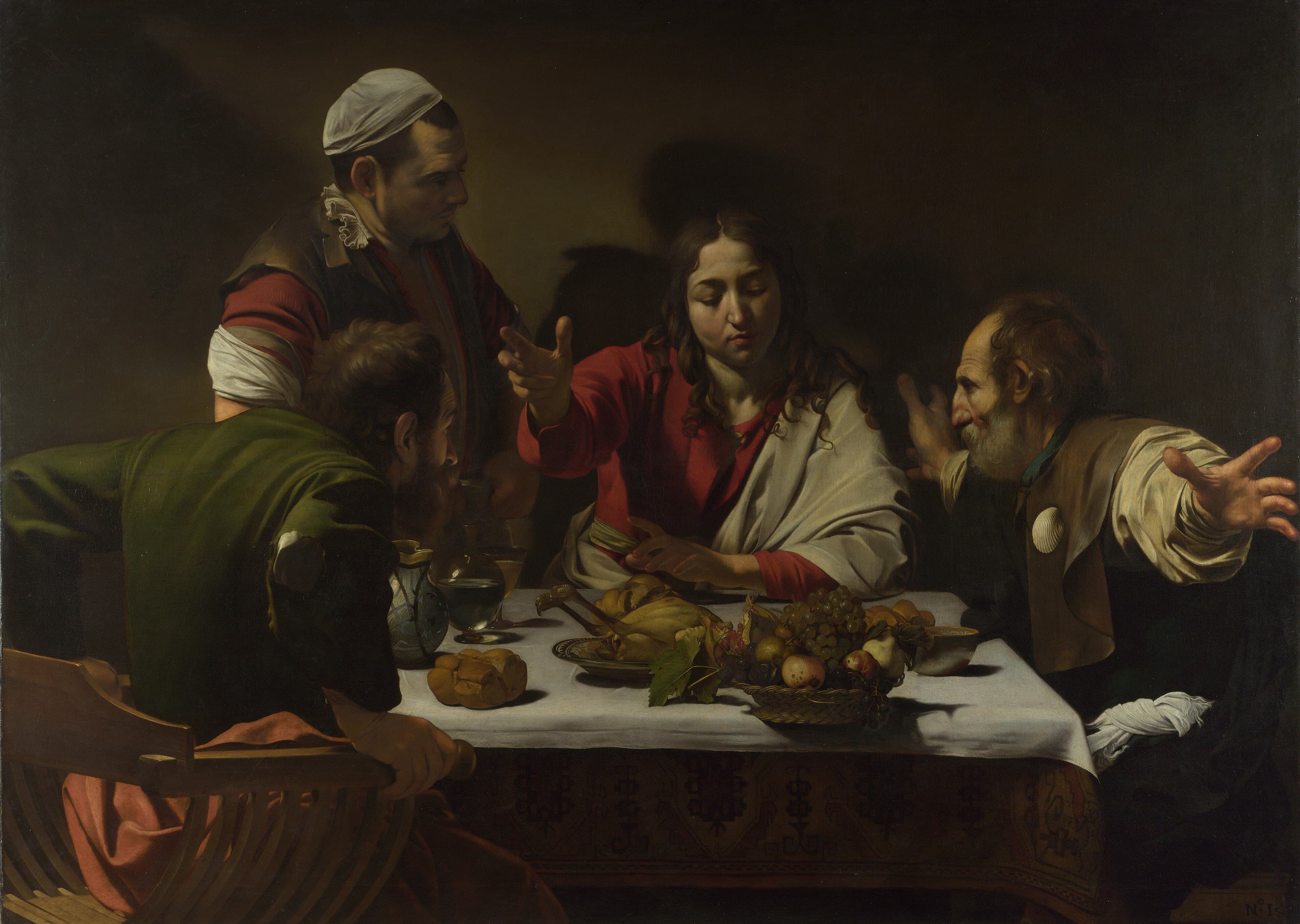 A young beardless Christ blesses food at a table as one disciple grips his chair and another flings out his arms, with a fruit basket at the table's edge — Caravaggio, Supper at Emmaus, 1601