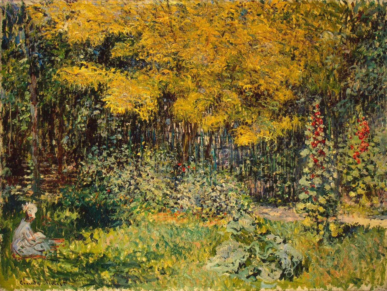 A sunlit garden with a golden-leaved tree, red hollyhocks, a dark fence and a woman in white seated small in the lower left corner — Claude Monet, The Garden, 1876