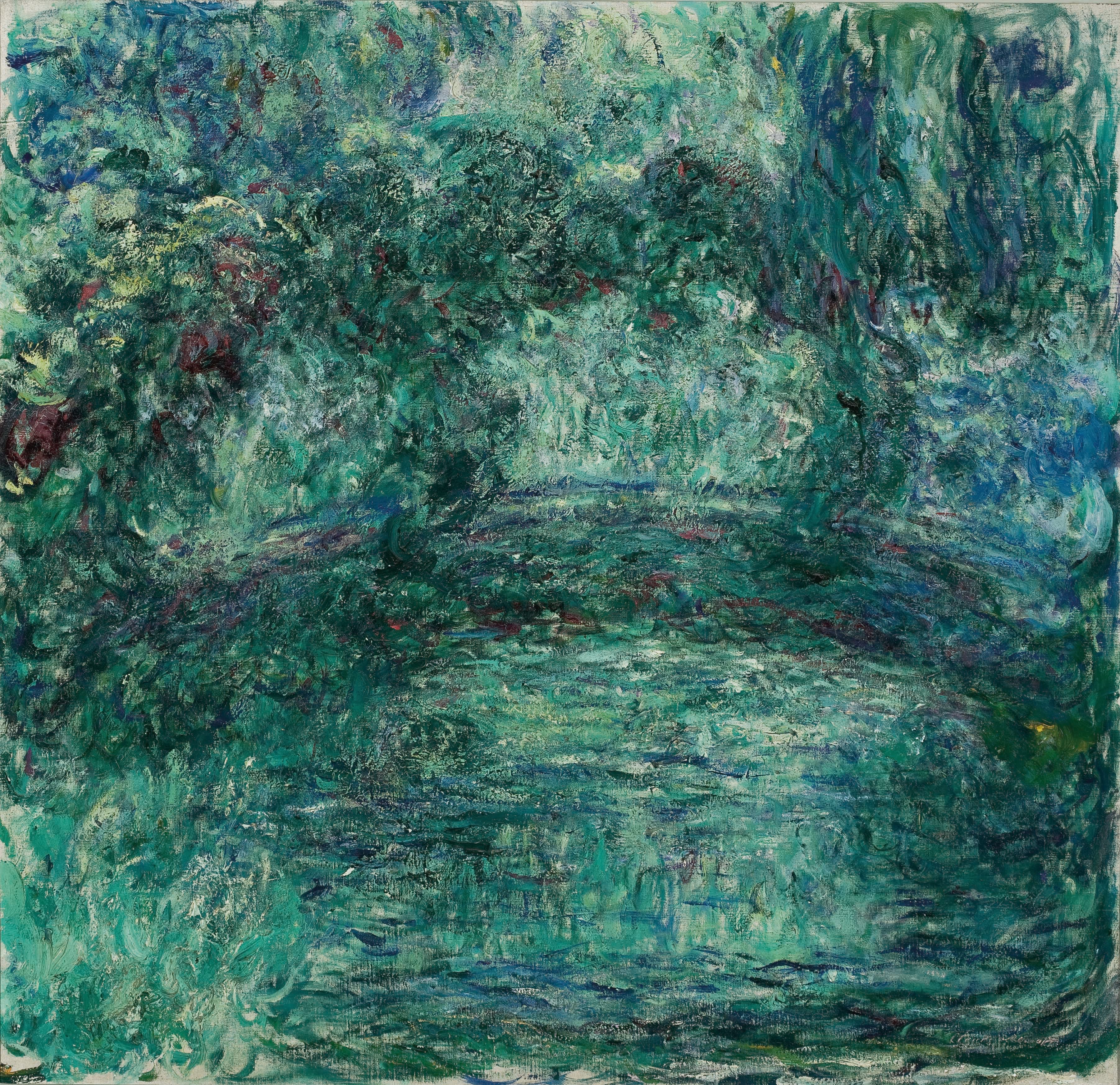 A broad arch of dark green spans a pond under a heaving mass of emerald foliage, painted in thick curling strokes — Claude Monet, The Japanese Bridge over the Water-Lily Pond, 1920–24