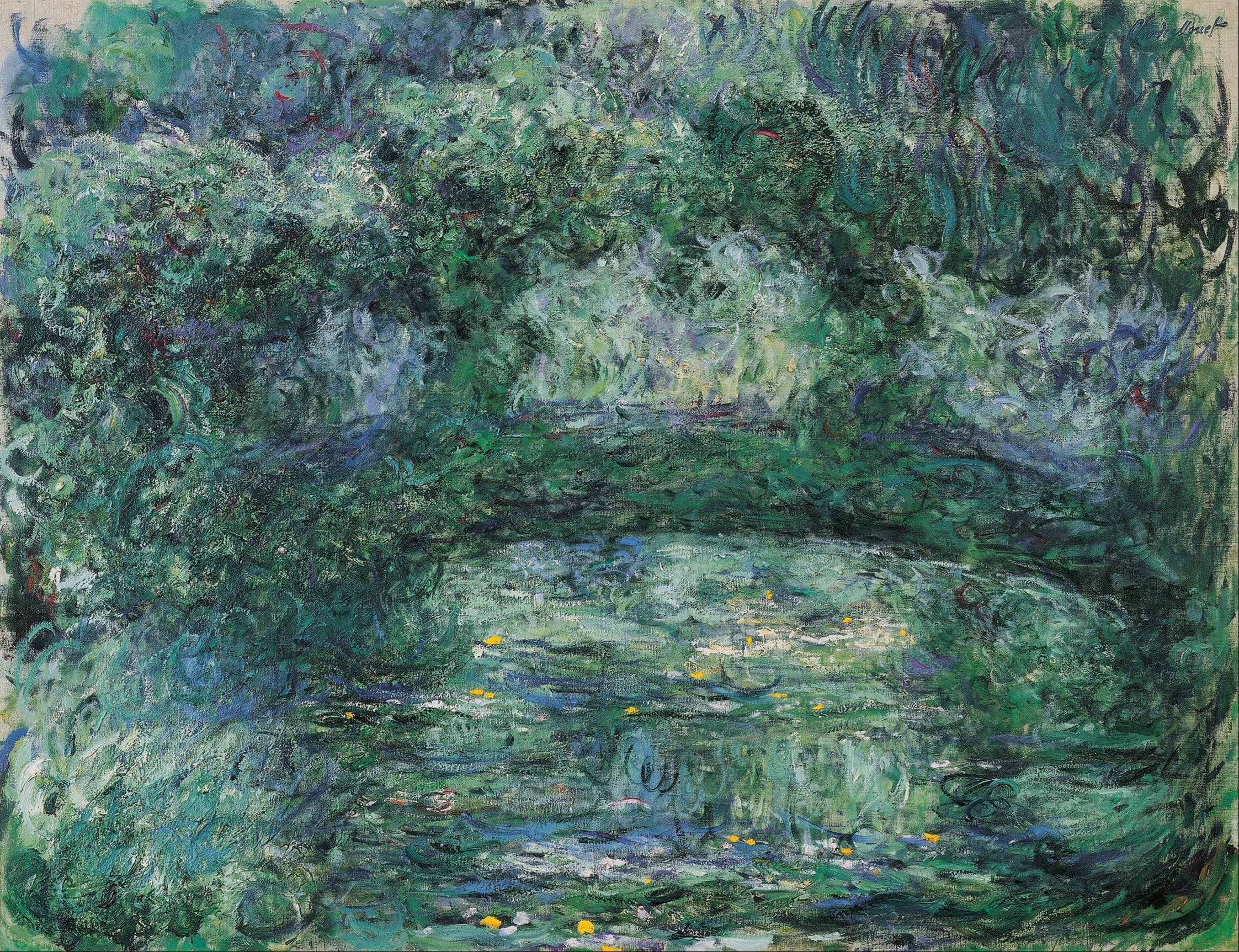 A dark green arch crosses a pale green pond dotted with small yellow flowers, beneath soft blue-green foliage and hanging willow — Claude Monet, The Japanese Bridge, 1918–24