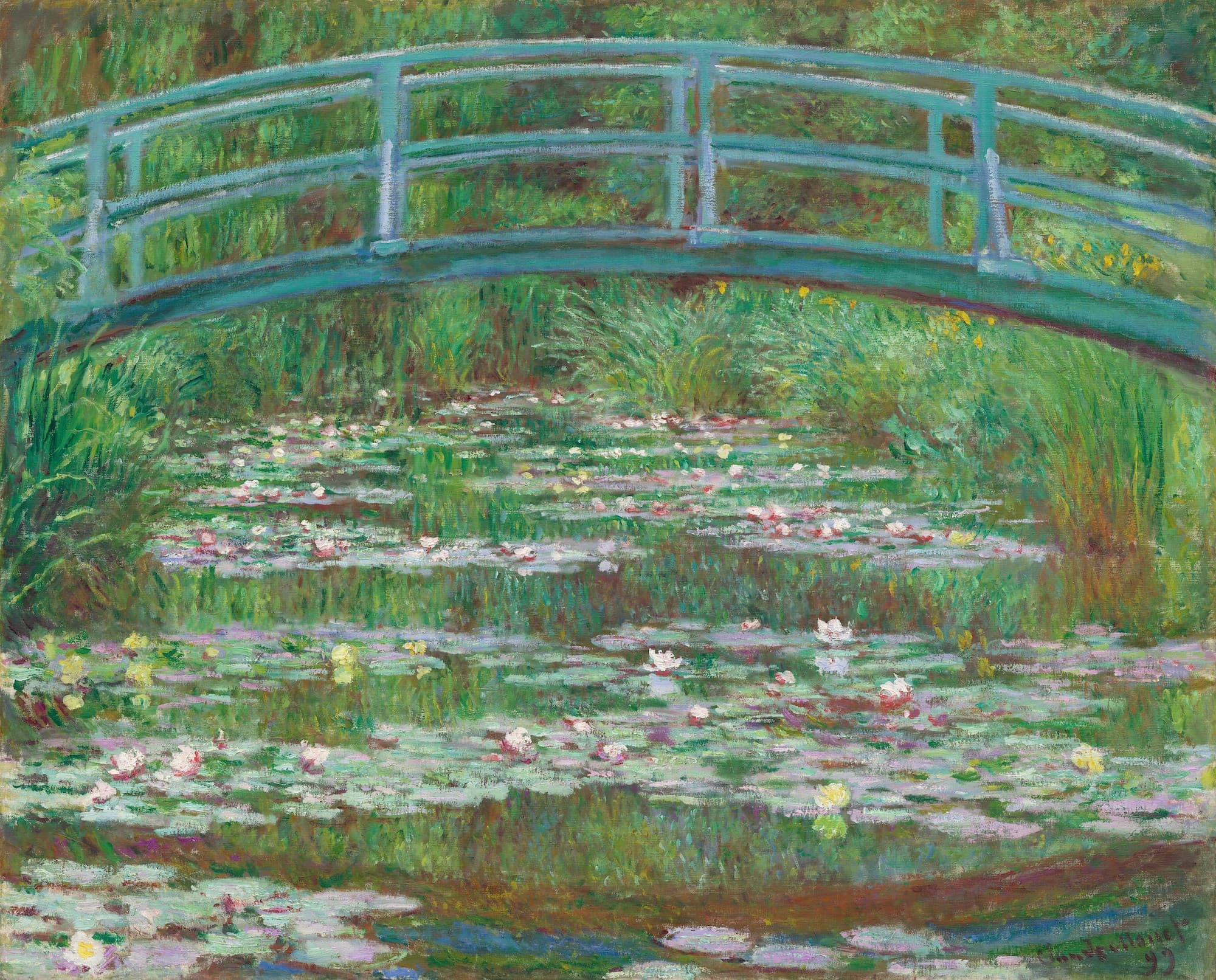 A blue-green arched footbridge spans the top of a pond covered in lily pads and white and pink water lilies — Claude Monet, The Japanese Footbridge, 1899