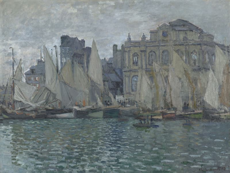 A grand stone museum building rises behind a crowd of grey sails moored along a quay, the harbor water rippling in the foreground under an overcast sky — Claude Monet, The Museum at Le Havre, 1873