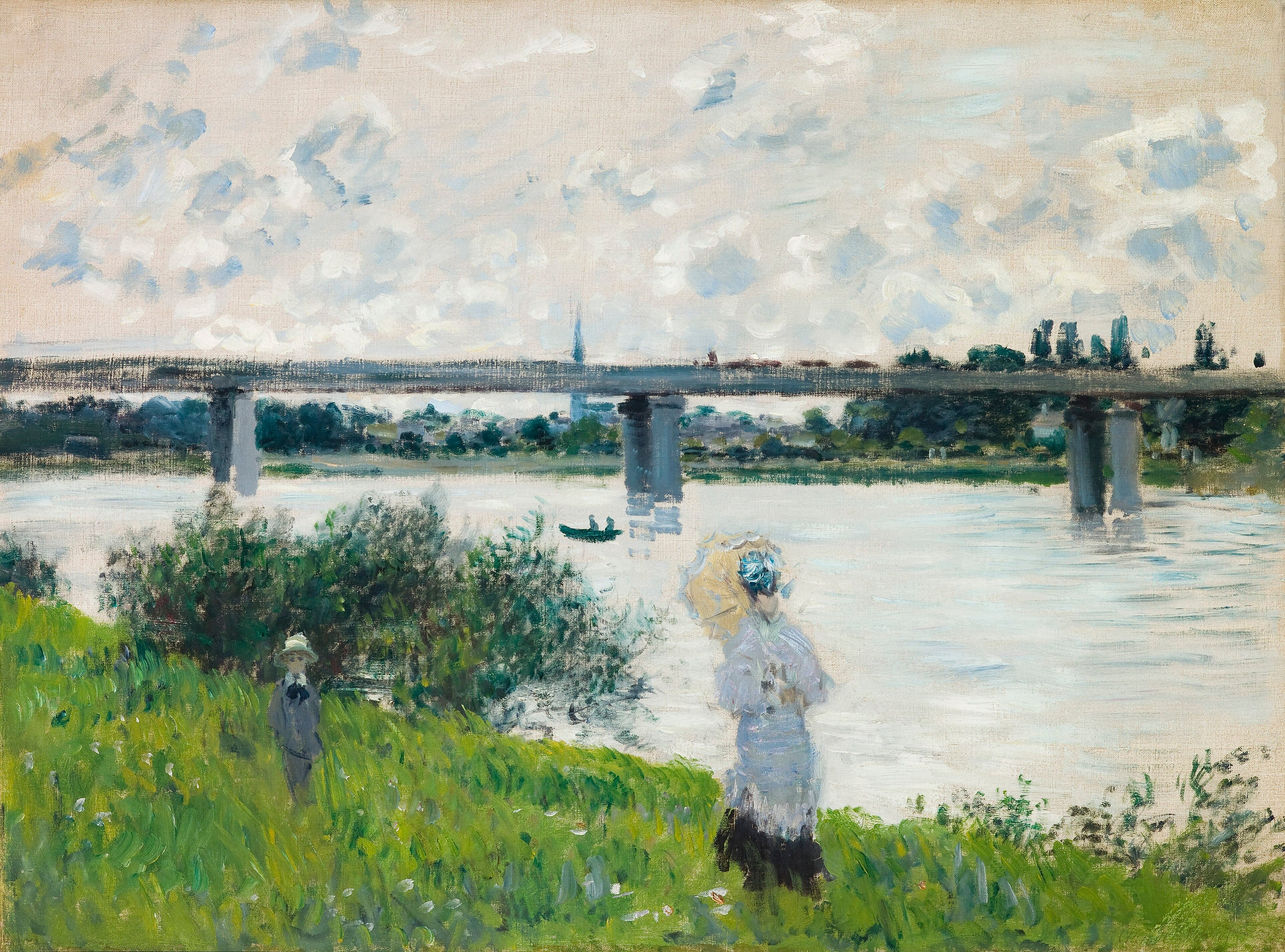 A woman with a parasol and a child stand on a grassy riverbank above the Seine, with a long railway bridge across the river under clouds — Claude Monet, The Promenade with the Railroad Bridge, Argenteuil, 1874