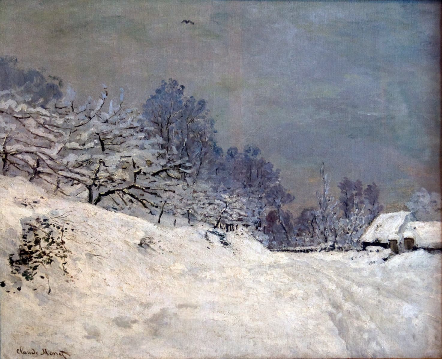 A deep snow-covered road climbs past frosted apple trees toward two snow-roofed cottages under a gray-green sky — Claude Monet, The Road in Front of Saint-Siméon Farm in Winter, 1867