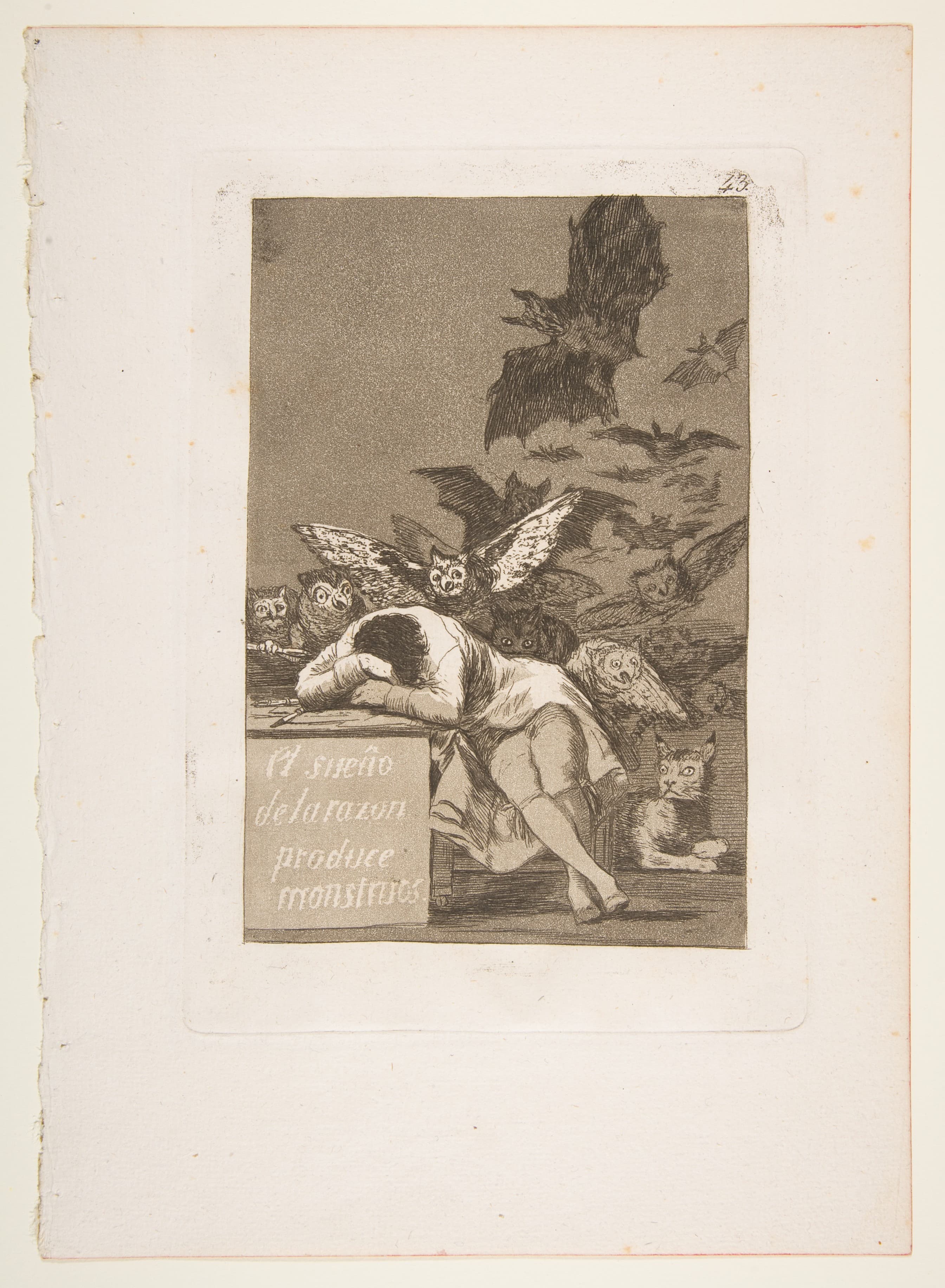 A man sleeps slumped over a desk while owls and bats swarm out of the darkness behind him and a lynx watches from the floor — Francisco Goya, The Sleep of Reason Produces Monsters, Los Caprichos plate 43, 1799