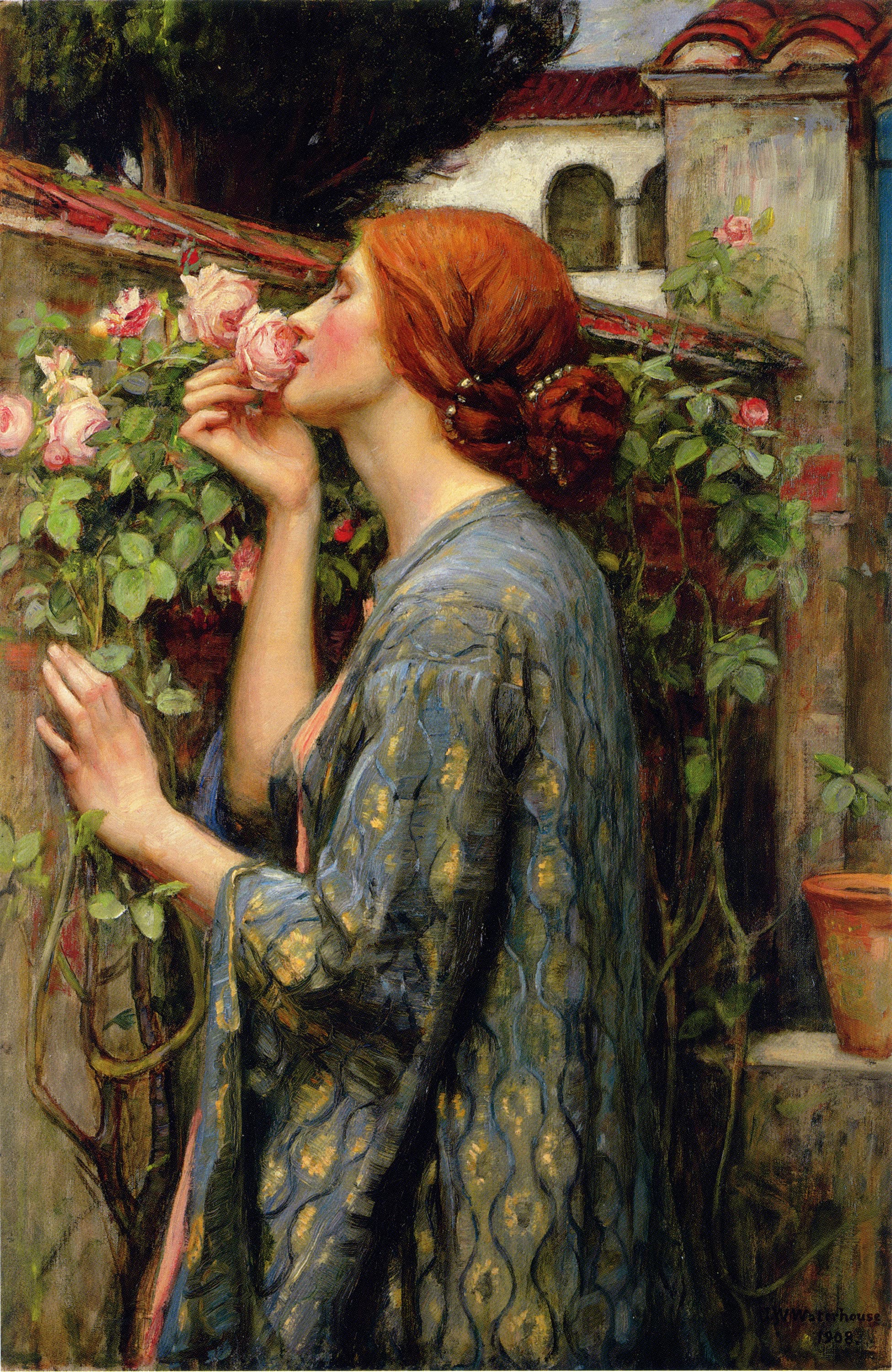 A red-haired woman in a blue and gold robe stands in profile in a walled garden, eyes closed, holding a pink rose to her face — John William Waterhouse, The Soul of the Rose, 1908