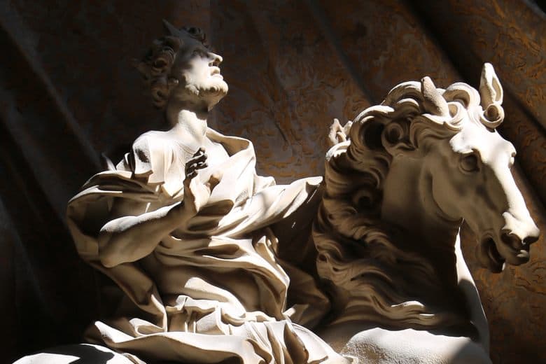 A marble emperor on a rearing horse looks up in awe with his hand on his chest, light falling across his face — Gian Lorenzo Bernini, The Vision of Constantine, 1654–70