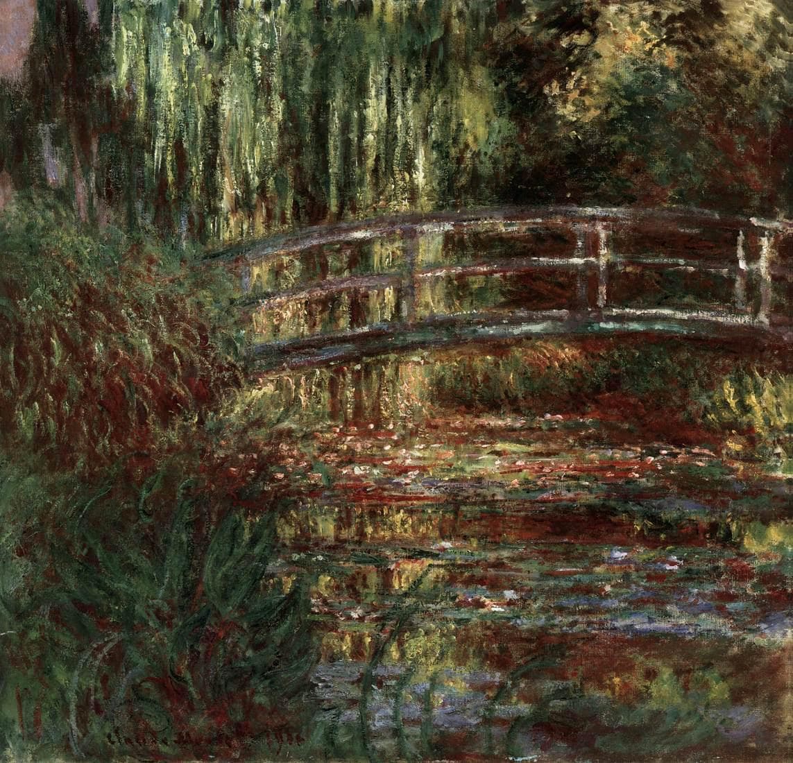 A wooden arched footbridge crosses a pond crowded with lily pads in red, green and violet beneath hanging willow branches — Claude Monet, The Water Lily Pond, 1900
