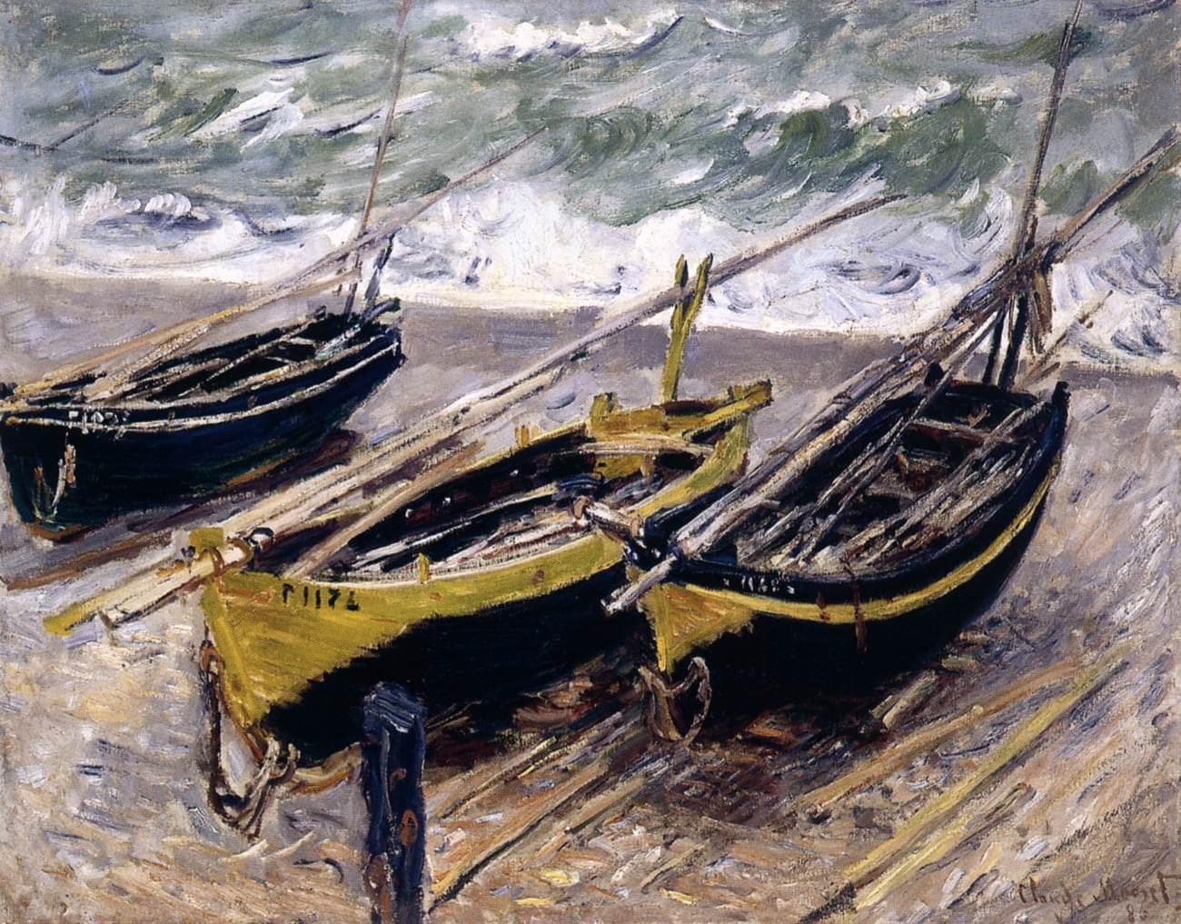Three wooden fishing boats, one yellow-green and two black, lie tilted on a stony beach with oars across them before a rough gray-green sea — Claude Monet, Three Fishing Boats, 1885