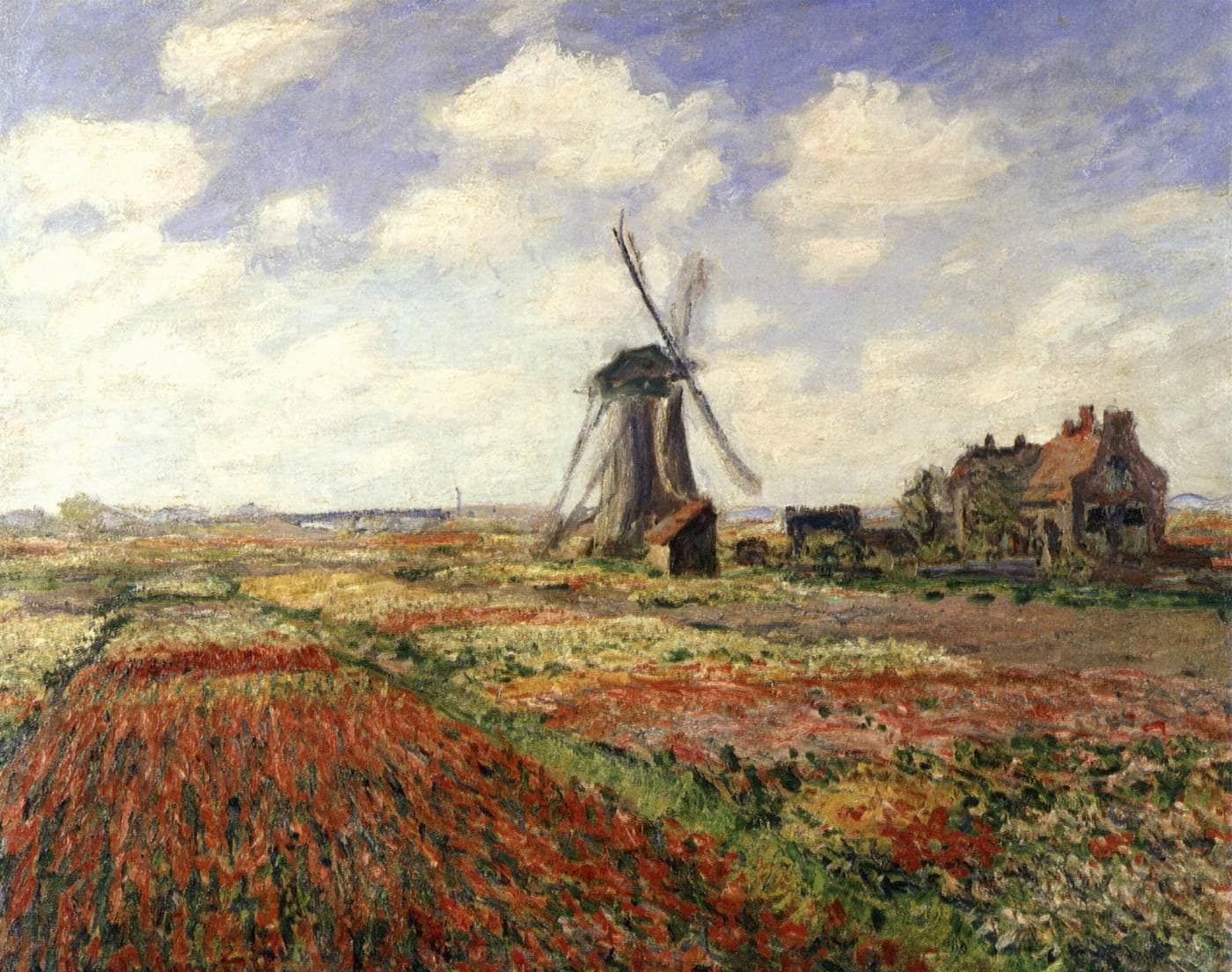 Stripes of red, yellow and white tulips stretch toward a windmill and a red-roofed farmhouse under a sky of white clouds — Claude Monet, Tulip Fields in Holland, 1886