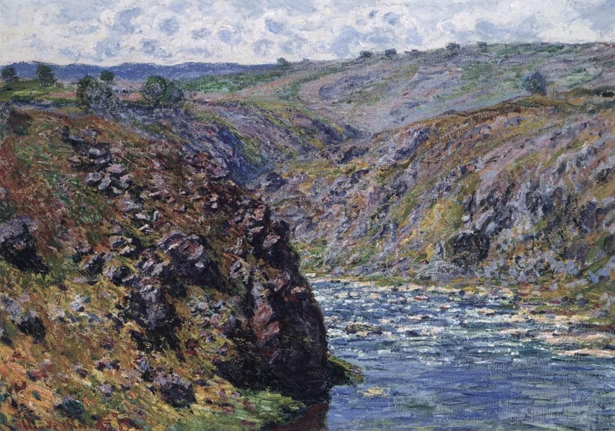 A steep rocky ravine in violet, ochre and green rises on both sides of a glittering blue river under a narrow strip of cloudy sky — Claude Monet, Valley of the Creuse (Sunlight Effect), 1889