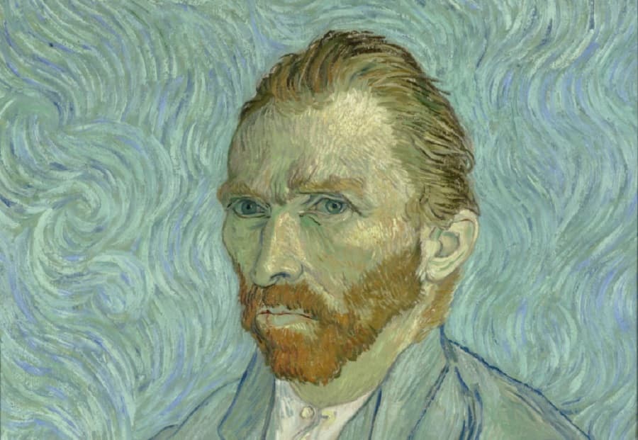 A red-bearded man in a pale blue jacket gazes sideways against a background of swirling blue and turquoise brushstrokes — Vincent van Gogh, Self-Portrait, 1889