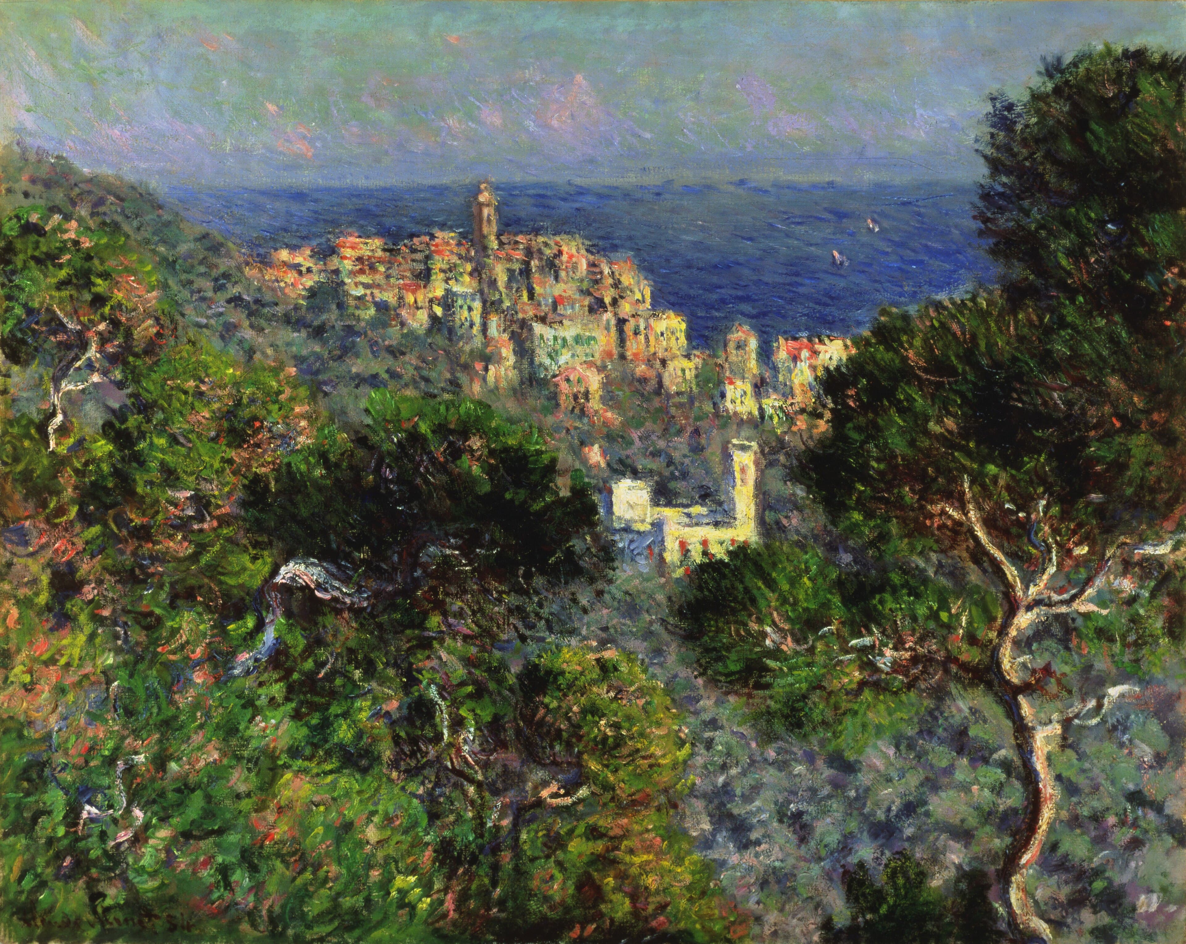 A cluster of pink and cream houses with a tall bell tower sits on a ridge between dark pines, with a deep blue sea and two small sails behind — Claude Monet, View of Bordighera, 1884