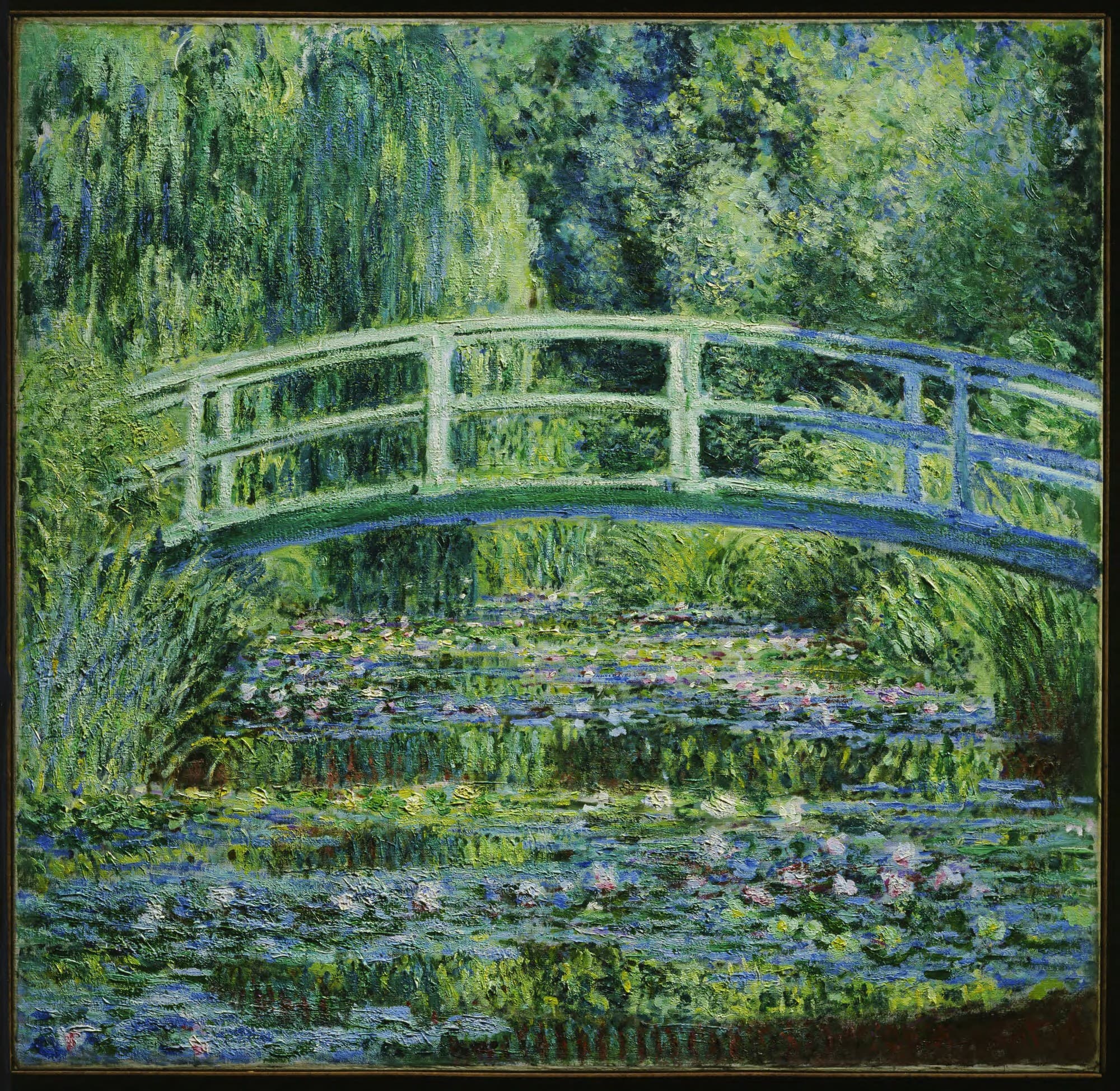 A blue-green arched footbridge crosses a pond covered with lily pads and pink and white flowers, a weeping willow at upper left — Claude Monet, Water Lilies and Japanese Bridge, 1899