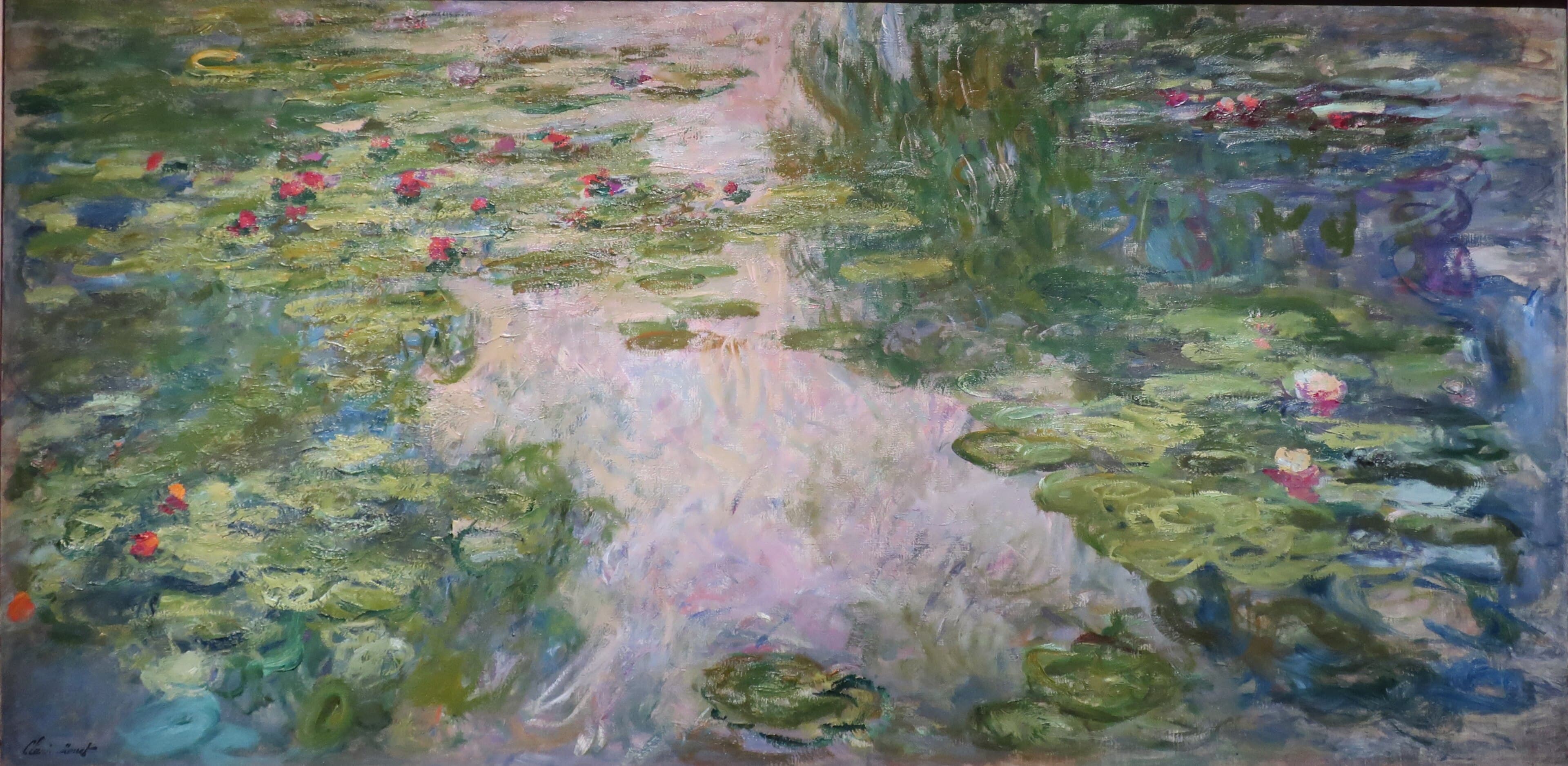 A broad pink and lilac reflection of sky runs down the middle of a pond, flanked by green lily pads with red and pink flowers — Claude Monet, Water Lilies, 1917–19