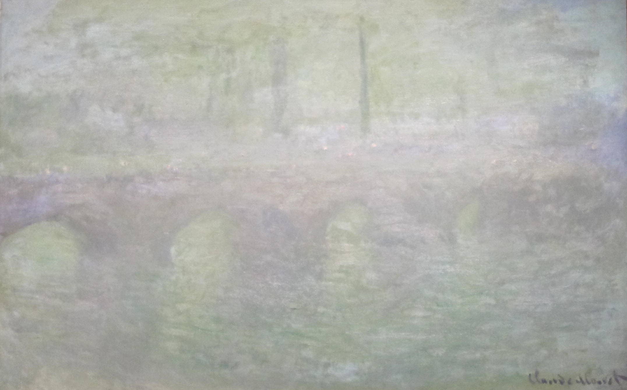 A long bridge barely visible through a pale green-gray haze, faint chimneys behind and tiny orange lights along its top — Claude Monet, Waterloo Bridge, London, at Dusk, 1904