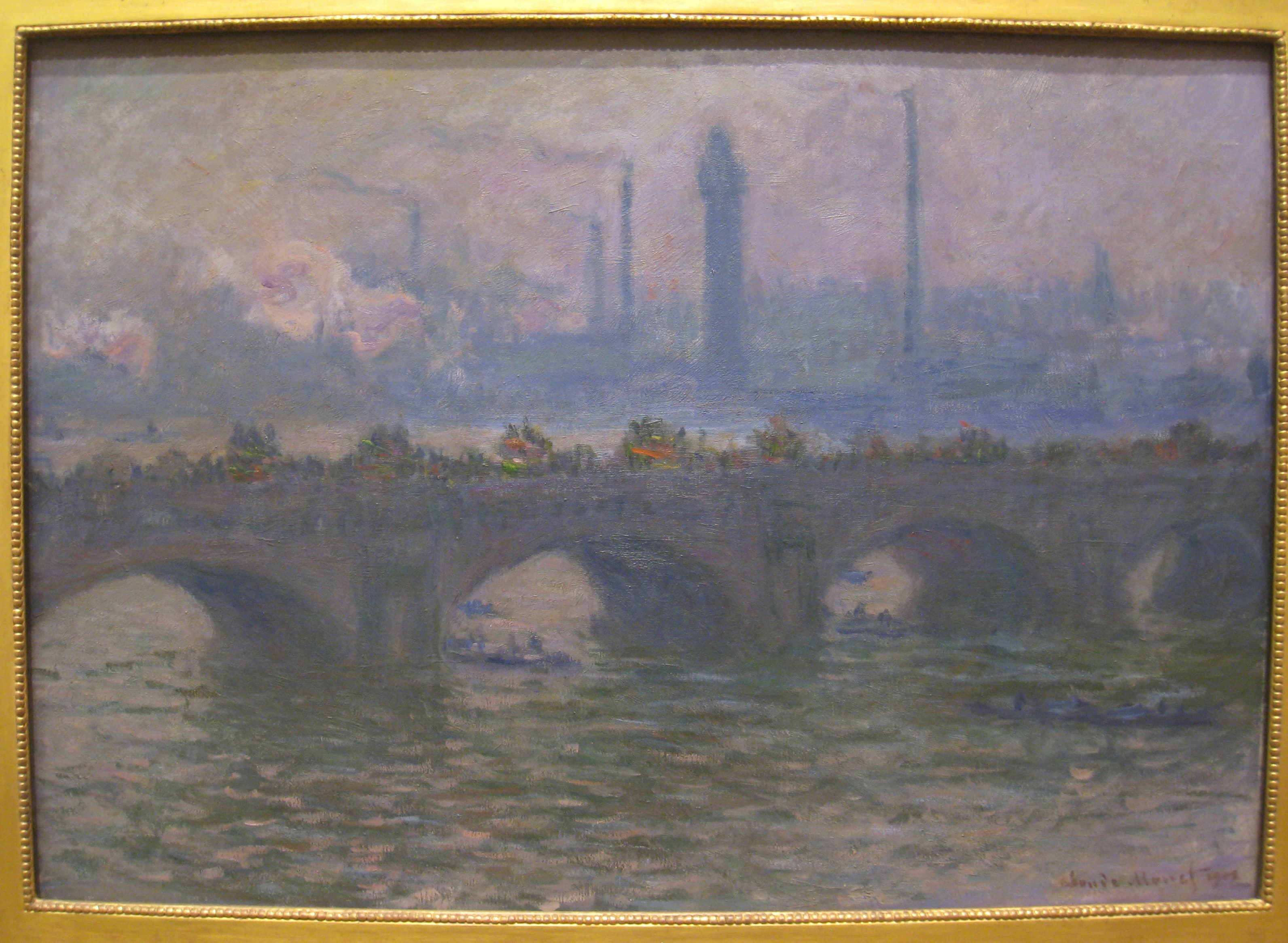 A gray-violet stone bridge with boats under its arches, pink smoke and factory chimneys rising behind it over the Thames — Claude Monet, Waterloo Bridge, 1903