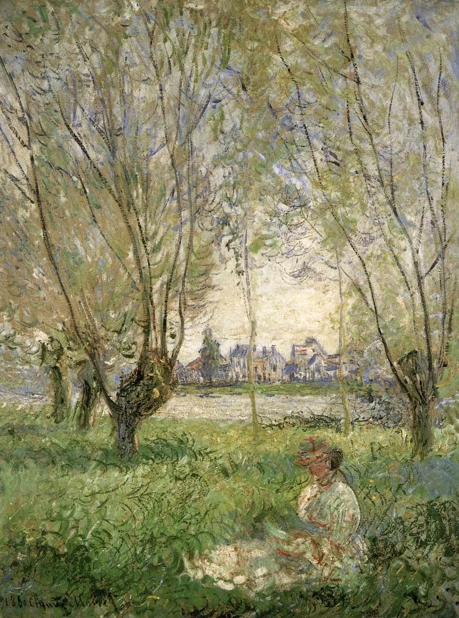 A woman in a light dress and red-trimmed hat sits in long grass beneath willows, with a sunlit village across a river beyond — Claude Monet, Woman Seated under the Willows, 1880